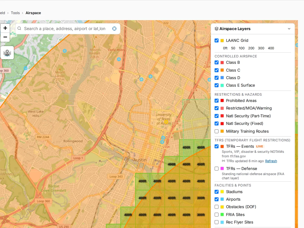 SkySuite airspace map over a city: controlled-airspace shading and LAANC grid ceilings, with the airspace, restriction and TFR layer list.